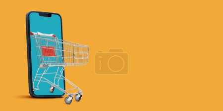 Photo for Shopping cart coming out of a smartphone screen: online shopping app - Royalty Free Image