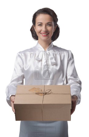 Photo for Smiling vintage woman holding a mail parcel package, shipping and delivery concept - Royalty Free Image
