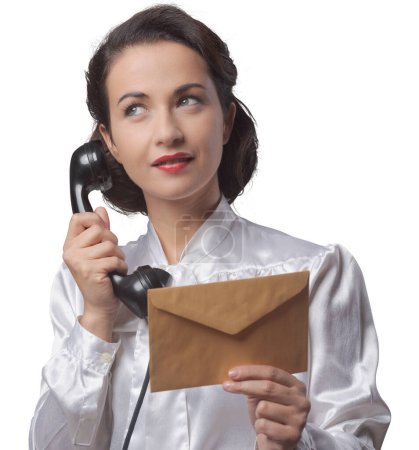 Photo for Vintage secretary on the phone holding a closed envelope - Royalty Free Image