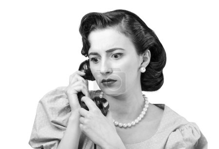 Photo for Worried woman on the phone, she is receiving bad news, vintage style - Royalty Free Image