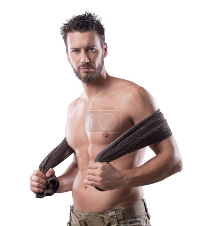 Photo for Confident muscular man drying his athletic body with a towel - Royalty Free Image