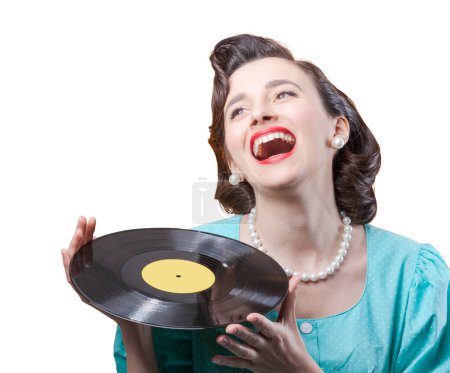 Photo for Cheerful vintage woman holding a vinyl record and laughing - Royalty Free Image