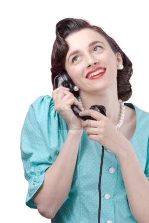 Photo for Vintage style woman holding the receiver and having a phone call, she is having a romantic call - Royalty Free Image