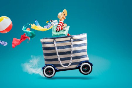 Photo for Happy woman riding a fast bag with wheels and going to the beach, summer vacations and travel concept, copy space - Royalty Free Image