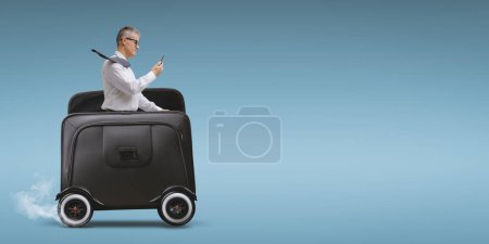 Photo for Businessman riding a fast briefcase with wheels and using smartphone, mobility concept - Royalty Free Image