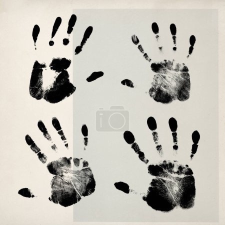 Foto de Black hand prints on vintage paper, togetherness and identity concept - Imagen libre de derechos