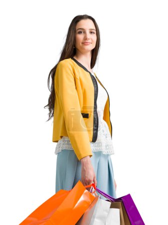 Photo for Smiling young woman enjoying shopping, she is holding a lot of shopping bags, fashion and sales concept - Royalty Free Image