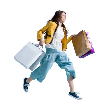 Foto de Alegre mujer feliz disfrutando de las compras: ella está llevando bolsas de compras y corriendo para obtener las últimas ofertas en el centro comercial - Imagen libre de derechos