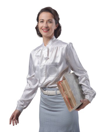 Photo for 1950s style secretary holding a folder with documents and paperwork - Royalty Free Image