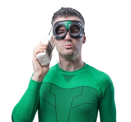 Foto de Divertido superhéroe en traje verde hablando por teléfono inalámbrico
. - Imagen libre de derechos