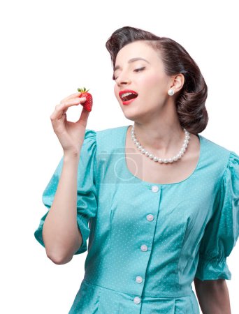Photo for Attractive vintage style sensual woman eating a juicy strawberry - Royalty Free Image