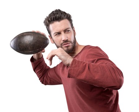 Photo for Handsome confident football player in red t-shirt launching ball - Royalty Free Image