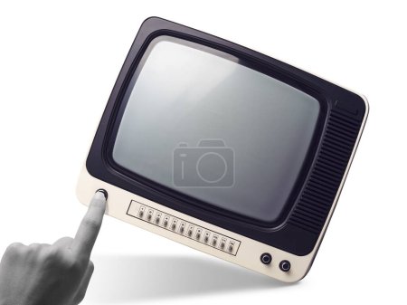 Photo for Woman touching a knob on a vintage TV: media and entertainment concept - Royalty Free Image