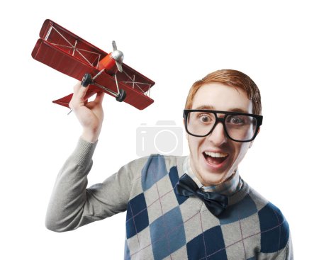 Photo for Childish guy playing with a vintage airplane, funny character concept - Royalty Free Image