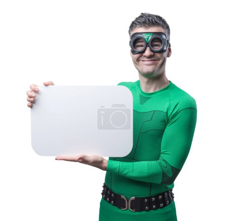 Photo for Funny green superhero holding an empty sign and looking at camera. - Royalty Free Image