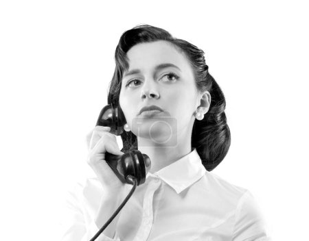 Photo for Confident serious vintage style secretary talking on the phone - Royalty Free Image