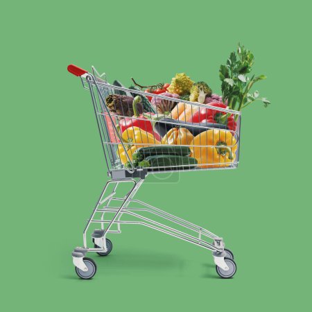 Photo for Shopping cart full of fresh vegetables: grocery shopping, sale and healthy food concept - Royalty Free Image