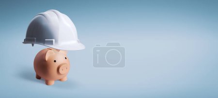 Téléchargez les photos : Grand casque de sécurité protégeant une tirelire : protégez votre épargne et vos investissements - en image libre de droit