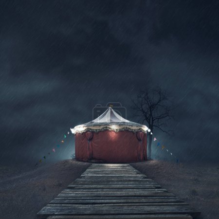 Photo for Scary vintage circus tent under the rain in the dark - Royalty Free Image