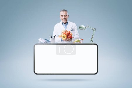 Photo for Professional nutritionist working in his office and smartphone with blank screen: telemedicine and online doctor concept - Royalty Free Image