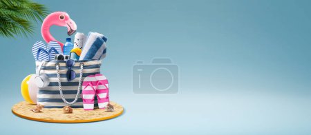Photo for Beach bag with accessories and cute inflatable flamingo: summer vacations at the beach concept, copy space - Royalty Free Image