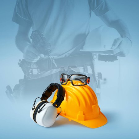 Photo for Safety helmet, ear muffs and goggles: personal protective equipment and workplace safety concept - Royalty Free Image