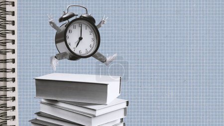 Photo for Happy alarm clock character running on a pile of books: vintage style creative composition, back to school and education concept - Royalty Free Image