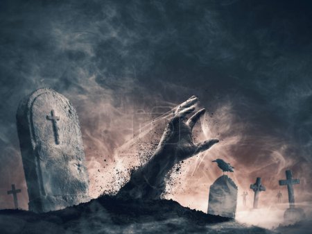 Photo for Zombie rising from the grave: creepy hand coming out of the ground and old tombstones - Royalty Free Image