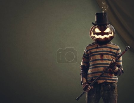 Photo for Evil pumpkin head monster wearing a top hat and holding a walking stick, Halloween and horror characters concept - Royalty Free Image