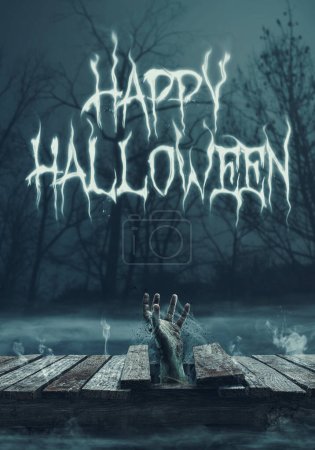 Photo for Happy Halloween wishes with zombie hand coming out of a wooden deck - Royalty Free Image