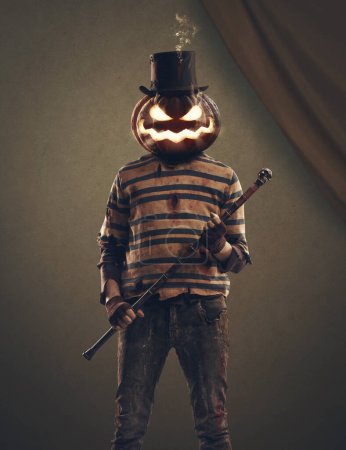 Foto de Malvado monstruo cabeza de calabaza con un sombrero de copa y sosteniendo un bastón, Halloween y el concepto de personajes de terror - Imagen libre de derechos