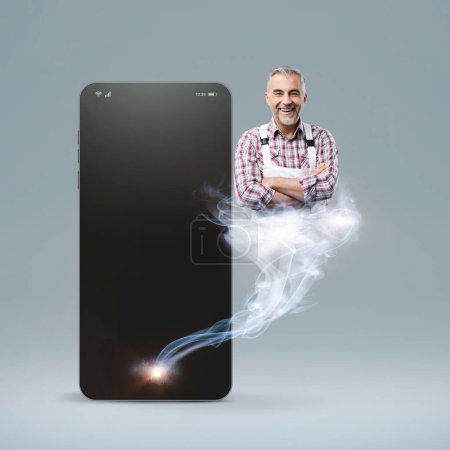 Photo for Professional smiling repairman appearing like a genie and coming out from a smartphone, hire a professional worker online concept - Royalty Free Image