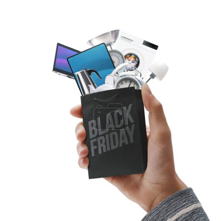 Photo for Customer holding a small shopping bag full of Black Friday offers - Royalty Free Image