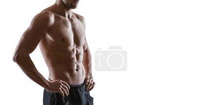 Photo for Handsome muscular man posing and showing his muscular body, fitness and sports concept, copy space - Royalty Free Image