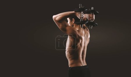 Photo for Handsome shirtless fit man standing and working out, he is lifting barbells - Royalty Free Image