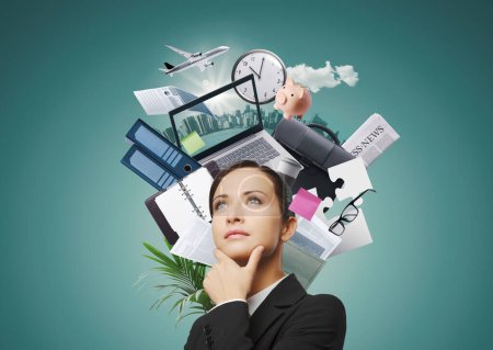 Photo for Confident pensive businesswoman with business items and office supplies around her head, she is making plans for her business and her career - Royalty Free Image