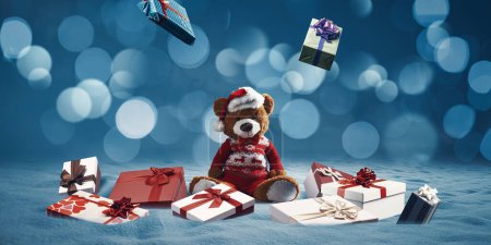 Photo for Christmas gifts falling from the sky and cute teddy bear wearing a Santa hat - Royalty Free Image