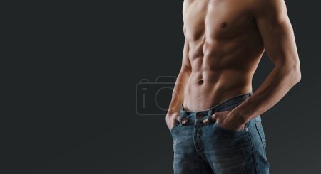 Photo for Handsome shirtless man posing and showing off his sexy body, he is wearing jeans - Royalty Free Image