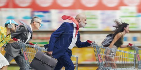 Photo for Fast people pushing shopping carts at the supermarket, offers and sales concept - Royalty Free Image