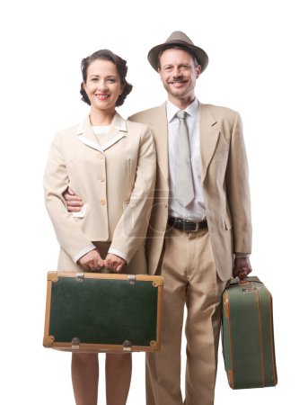 Photo for Vintage loving couple leaving for honeymoon with luggage, 1950s style - Royalty Free Image