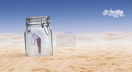 Photo for Desperate young woman trapped in a glass jar in the desert - Royalty Free Image