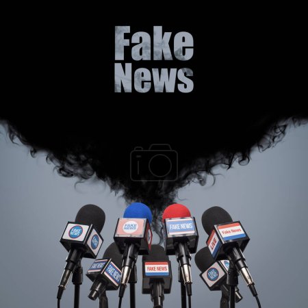 Photo for Microphones prepared for the press conference and black smoke: fake news, propaganda and disinformation concept - Royalty Free Image