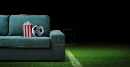 Photo for Couch with soccer ball and popcorn: watch live stream soccer and sports on TV at home - Royalty Free Image