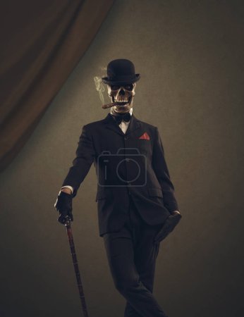 Photo for Scary horror character with skull head wearing an elegant suit and posing - Royalty Free Image