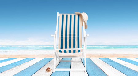 Photo for Striped deckchair at the beach on a wooden deck, summer vacations background - Royalty Free Image