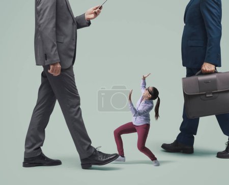 Scared tiny woman shouting and protecting herself, she is surrounded by giant businessmen