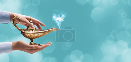 Photo for Woman holding the Genie's lamp and making a wish, fairy tales and magic concept, blank copy space - Royalty Free Image