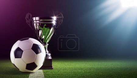 Photo for Shiny champions cup and football ball on the stadium field, sports and celebration concept, copy space - Royalty Free Image
