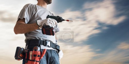 Photo for Professional repairman using a drill: do it yourself and home renovation concept - Royalty Free Image