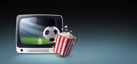 Téléchargez les photos : Ballon de football sortant d'un écran de télévision vintage et frappant une boîte de pop-corn : regarder le football en direct et le sport à la télévision - en image libre de droit